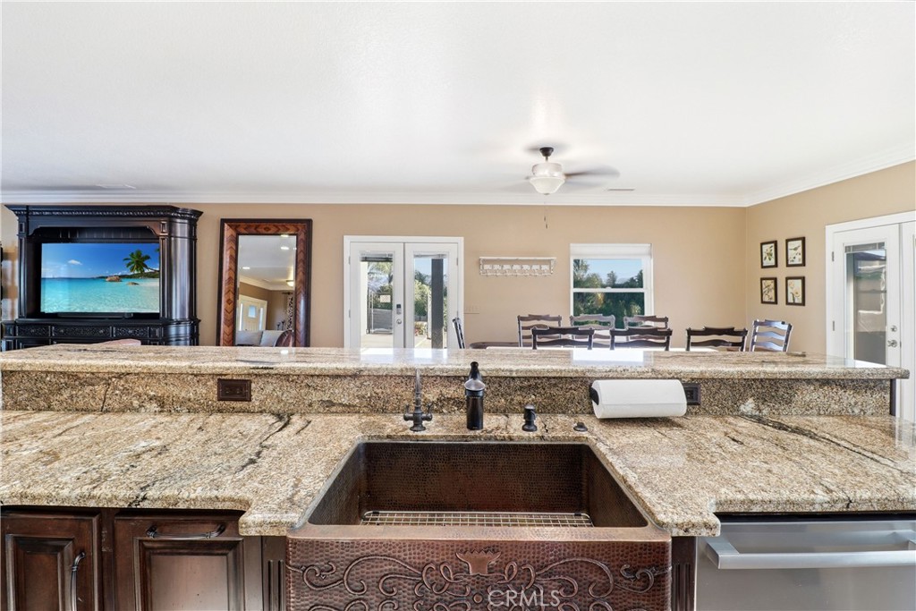 16025 Perry Heights Drive Riverside, CA 92504 - Photo 21 of 52 a kitchen with granite countertop a stove and white cabinets