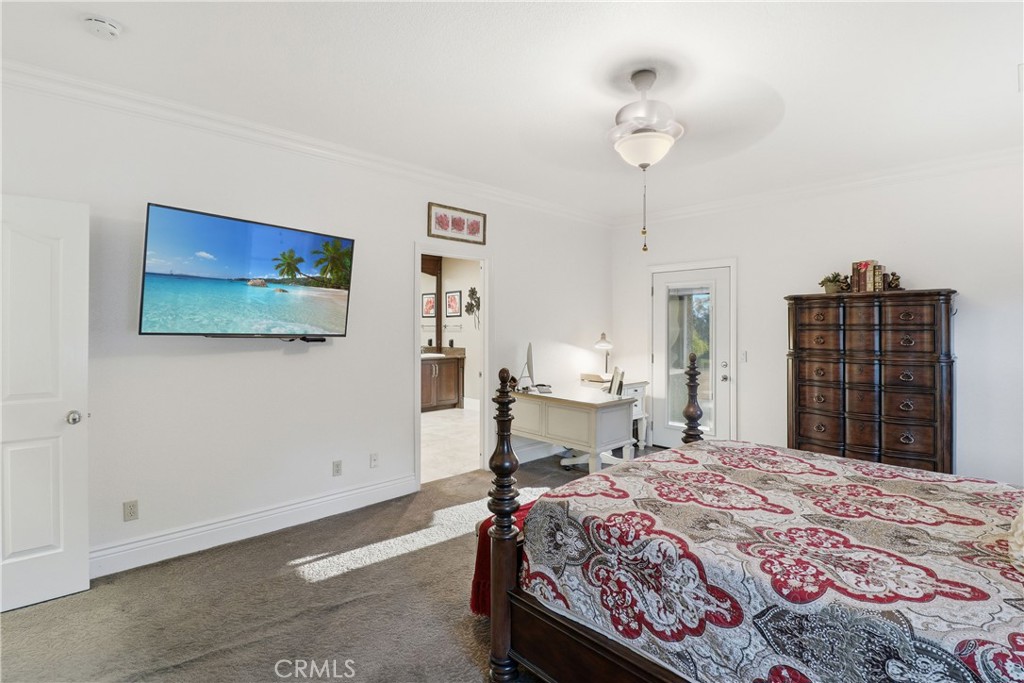 16025 Perry Heights Drive Riverside, CA 92504 - Photo 31 of 52 a bedroom with a bed and a chandelier