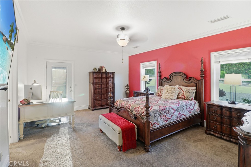 16025 Perry Heights Drive Riverside, CA 92504 - Photo 33 of 52 a bedroom with a bed and a chandelier