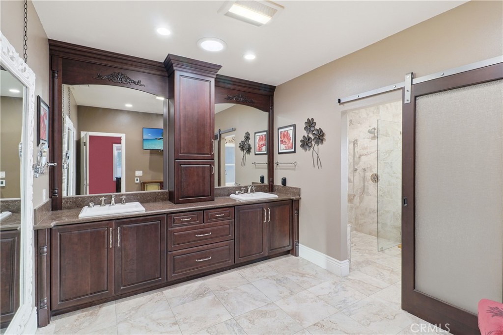 16025 Perry Heights Drive Riverside, CA 92504 - Photo 35 of 52 a bathroom with a granite countertop sink mirror and a