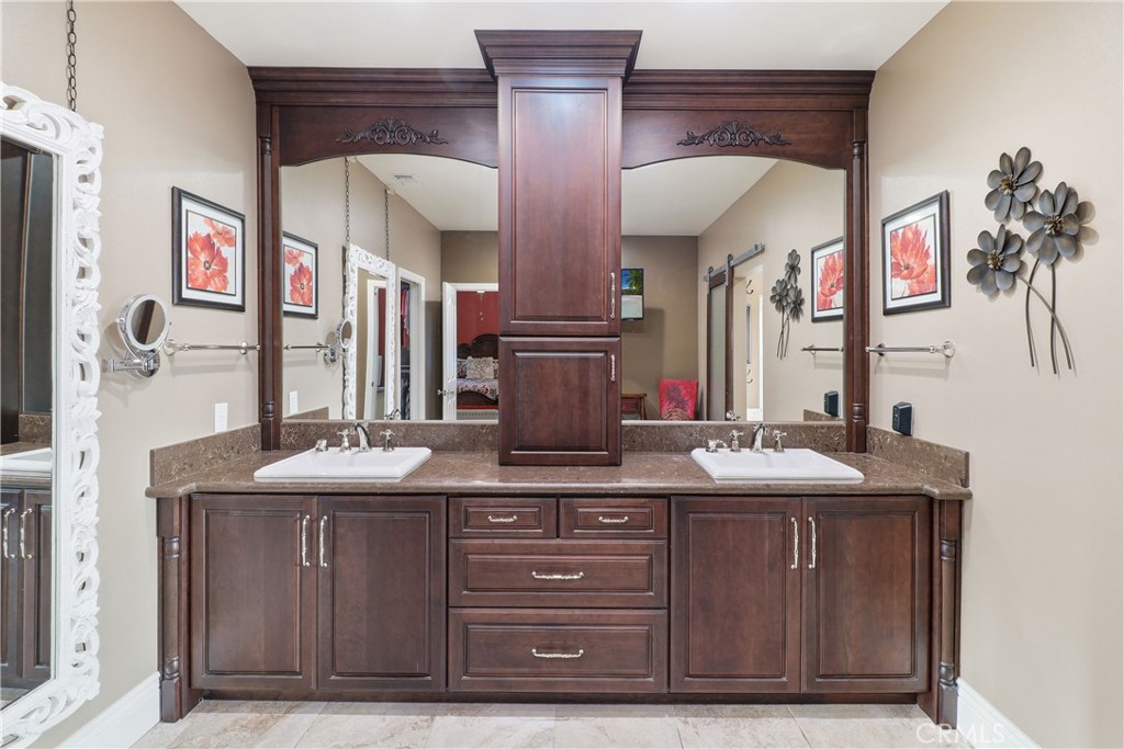 16025 Perry Heights Drive Riverside, CA 92504 - Photo 36 of 52 a bathroom with a granite countertop sink and a mirror