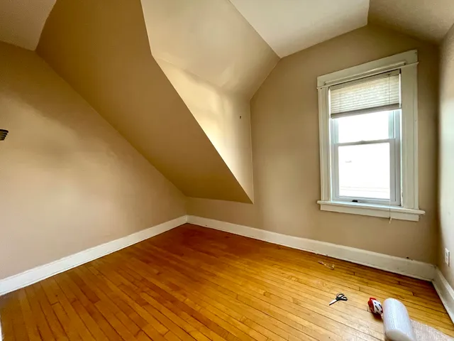 a view of a room with wooden floor and brick walls