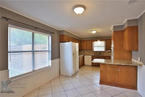 a kitchen with a refrigerator and cabinets