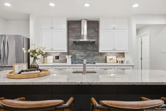 a kitchen with a sink and white cabinets