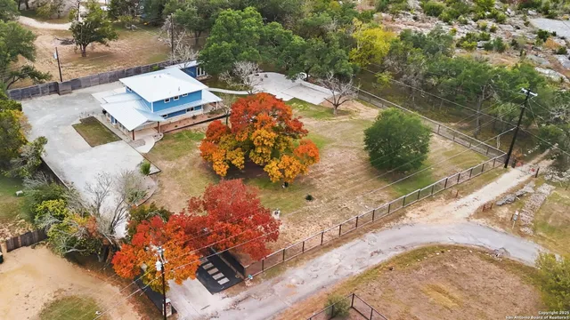 an aerial view of a house with a yard