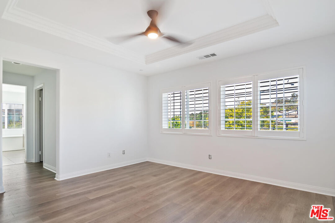 291 Santa Susana Road Camarillo, CA 93010 - Photo 14 of 32 an empty room with wooden floor and windows