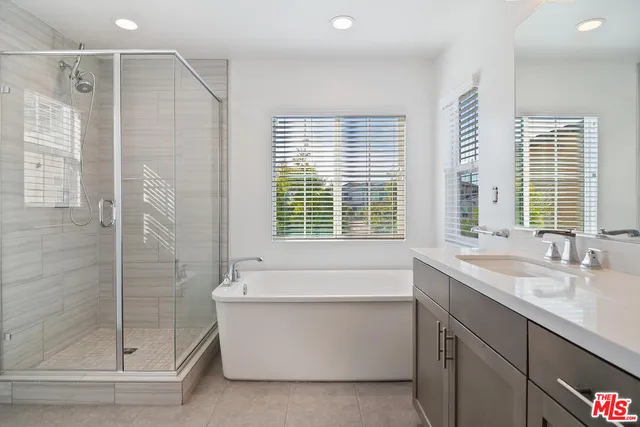 a bathroom with a bathtub and shower