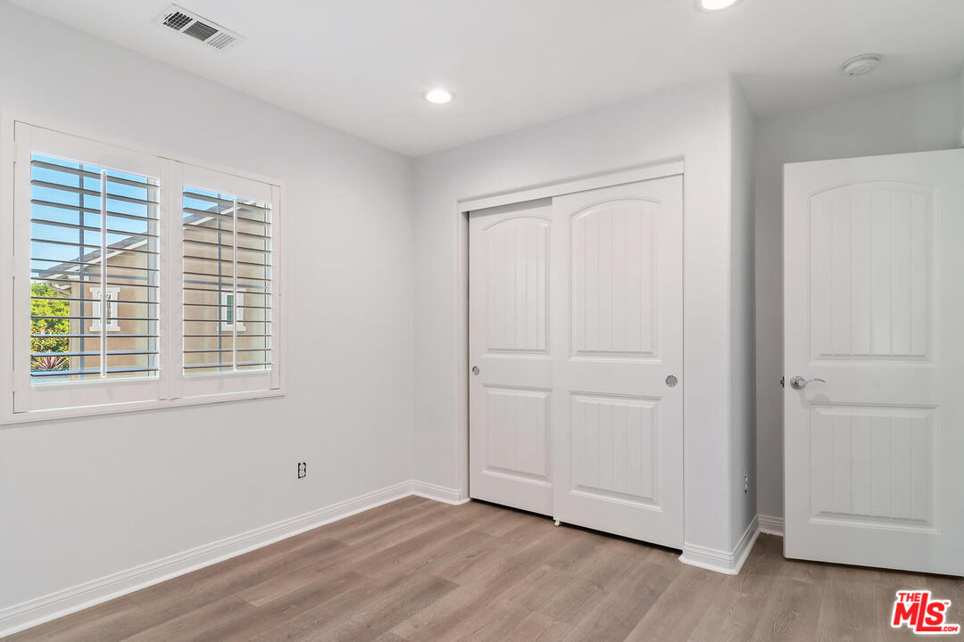 291 Santa Susana Road Camarillo, CA 93010 - Photo 20 of 32 a view of an empty room with wooden floor and a window
