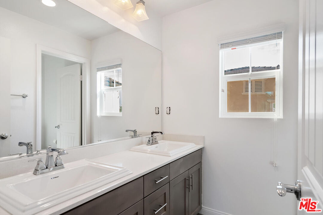291 Santa Susana Road Camarillo, CA 93010 - Photo 21 of 32 a bathroom with a sink vanity and a mirror