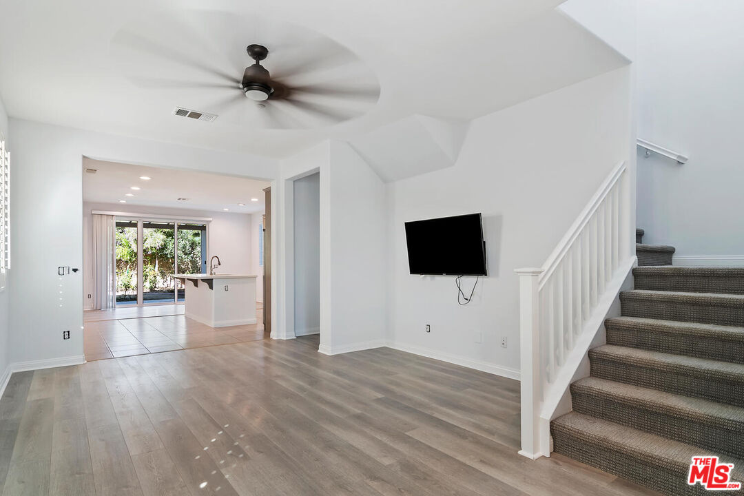 291 Santa Susana Road Camarillo, CA 93010 - Photo 4 of 32 a view of a livingroom with wooden floor a ceiling fan and windows