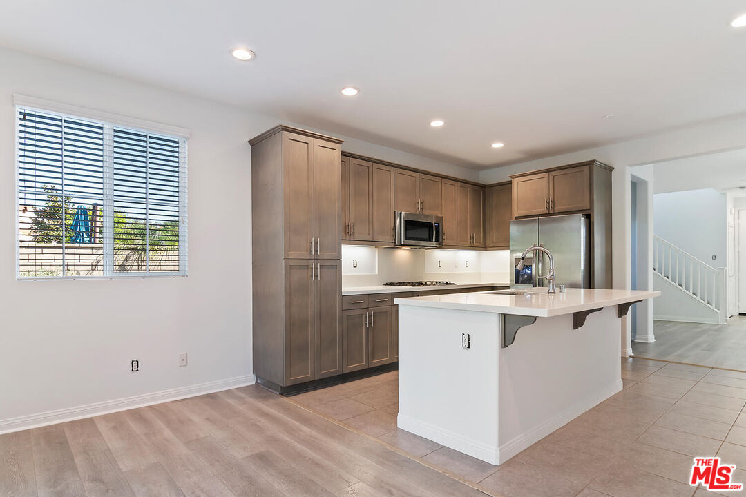 291 Santa Susana Road Camarillo, CA 93010 - Photo 9 of 32 a kitchen with stainless steel appliances a sink a stove a refrigerator cabinets and a window