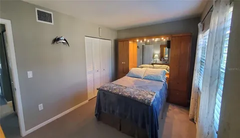 a hallway with a bed and wooden floor