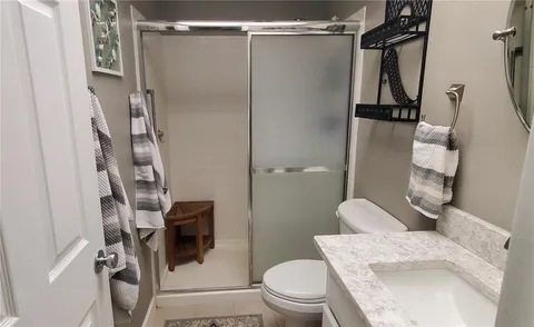 a bathroom with a shower toilet and sink