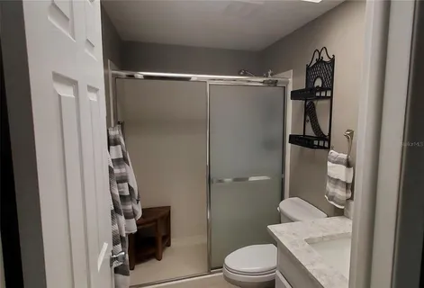a bathroom with a toilet and a shower