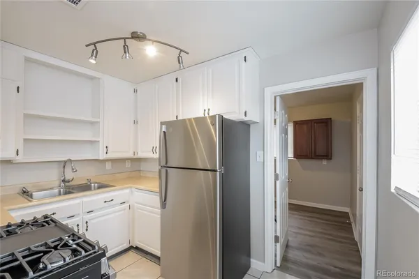 a kitchen with a refrigerator and a sink
