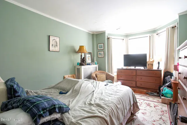 a bedroom with furniture and a window