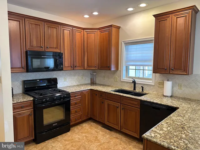 a kitchen with a refrigerator and a sink