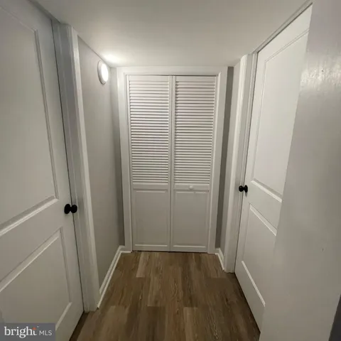 a view of a bathroom with wooden floor and a sink
