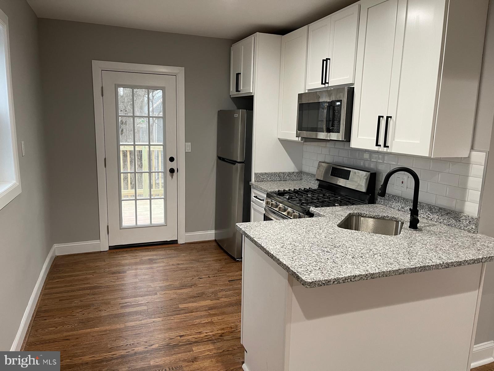 273 56th Place Northeast Washington, DC 20019 - Photo 2 of 25 a kitchen with granite countertop a sink stove and refrigerator