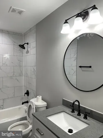 a bathroom with a sink and mirror