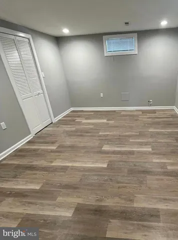 a view of a room with wooden floor