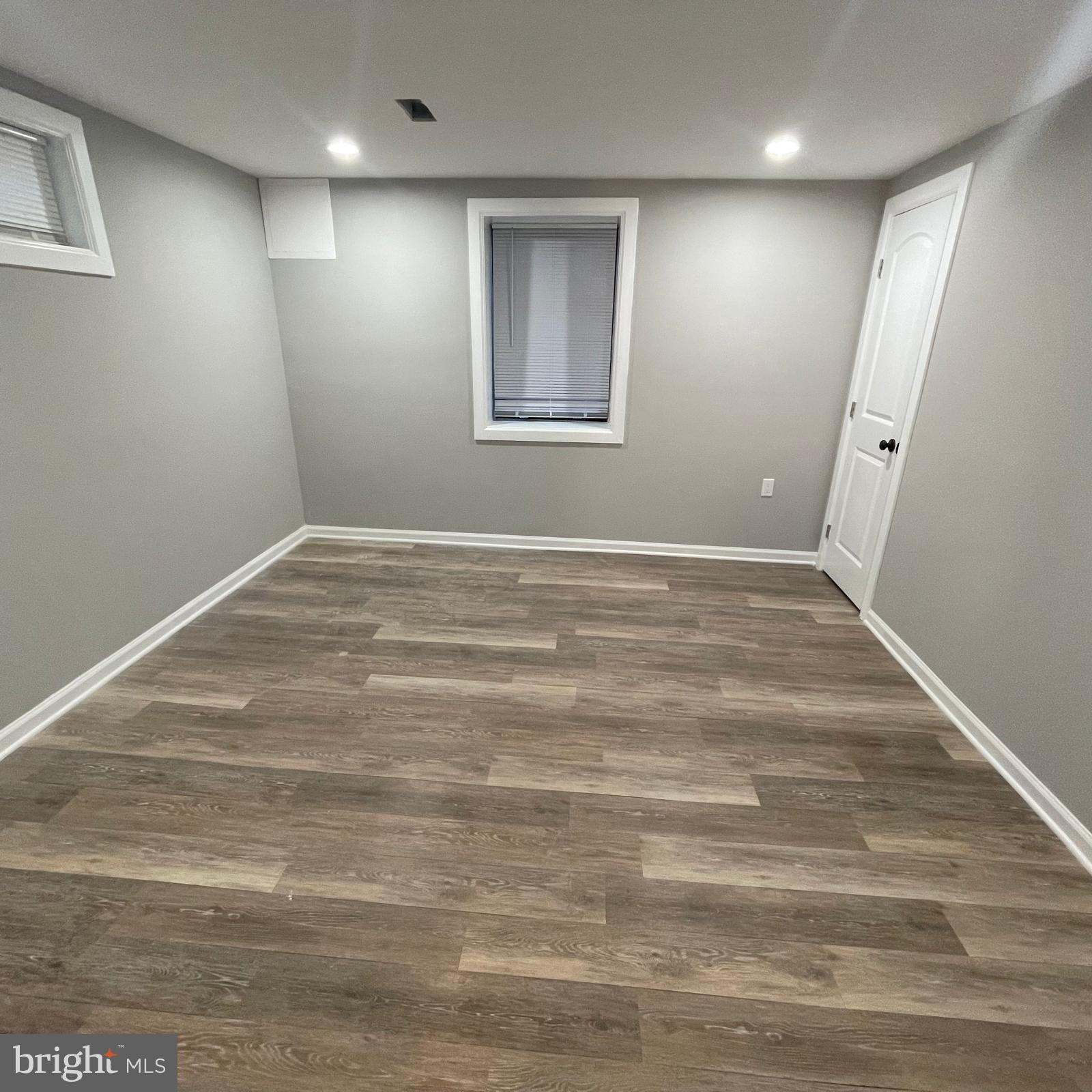 273 56th Place Northeast Washington, DC 20019 - Photo 7 of 25 a view of an empty room with wooden floor and a window
