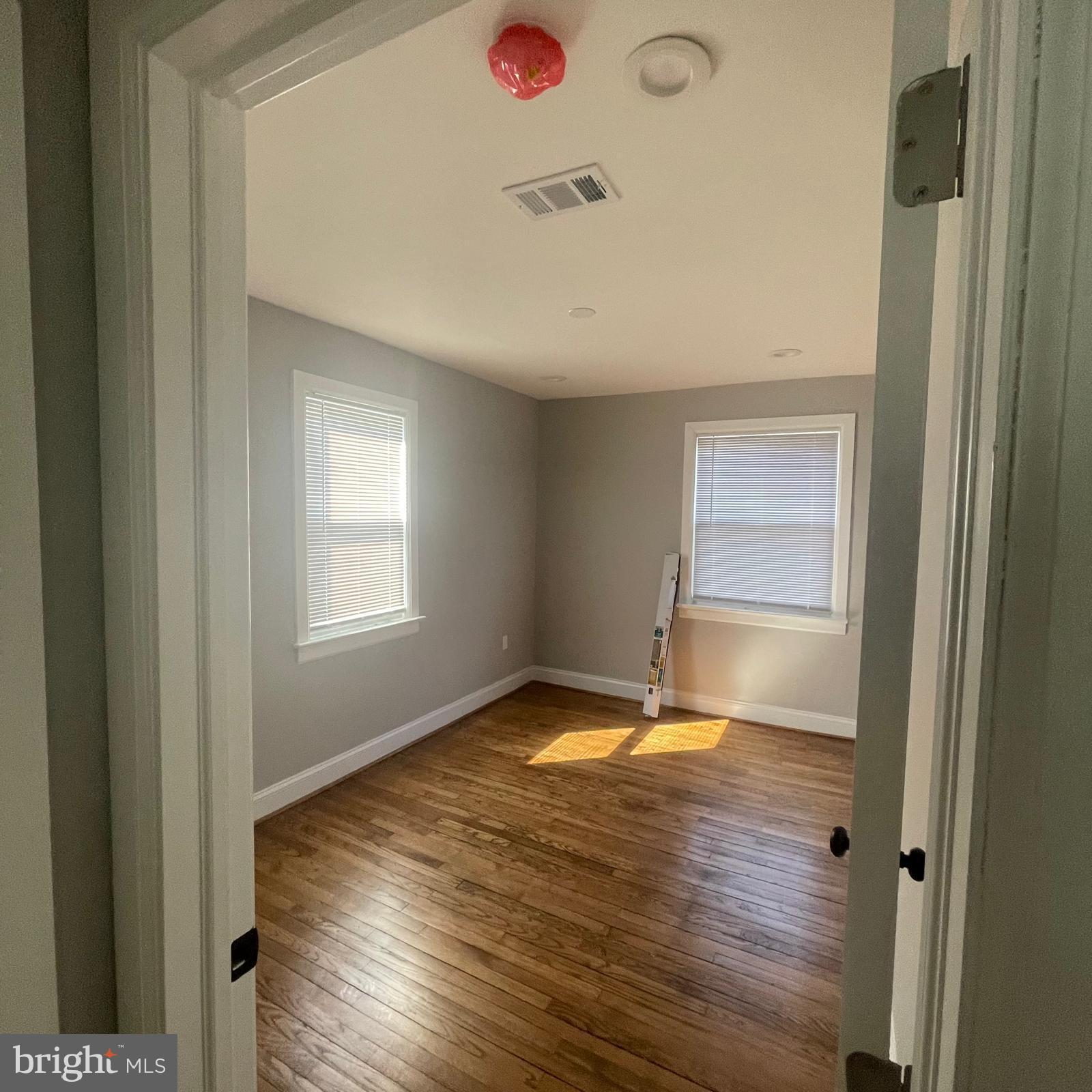 273 56th Place Northeast Washington, DC 20019 - Photo 8 of 25 a view of an empty room with wooden floor and a window