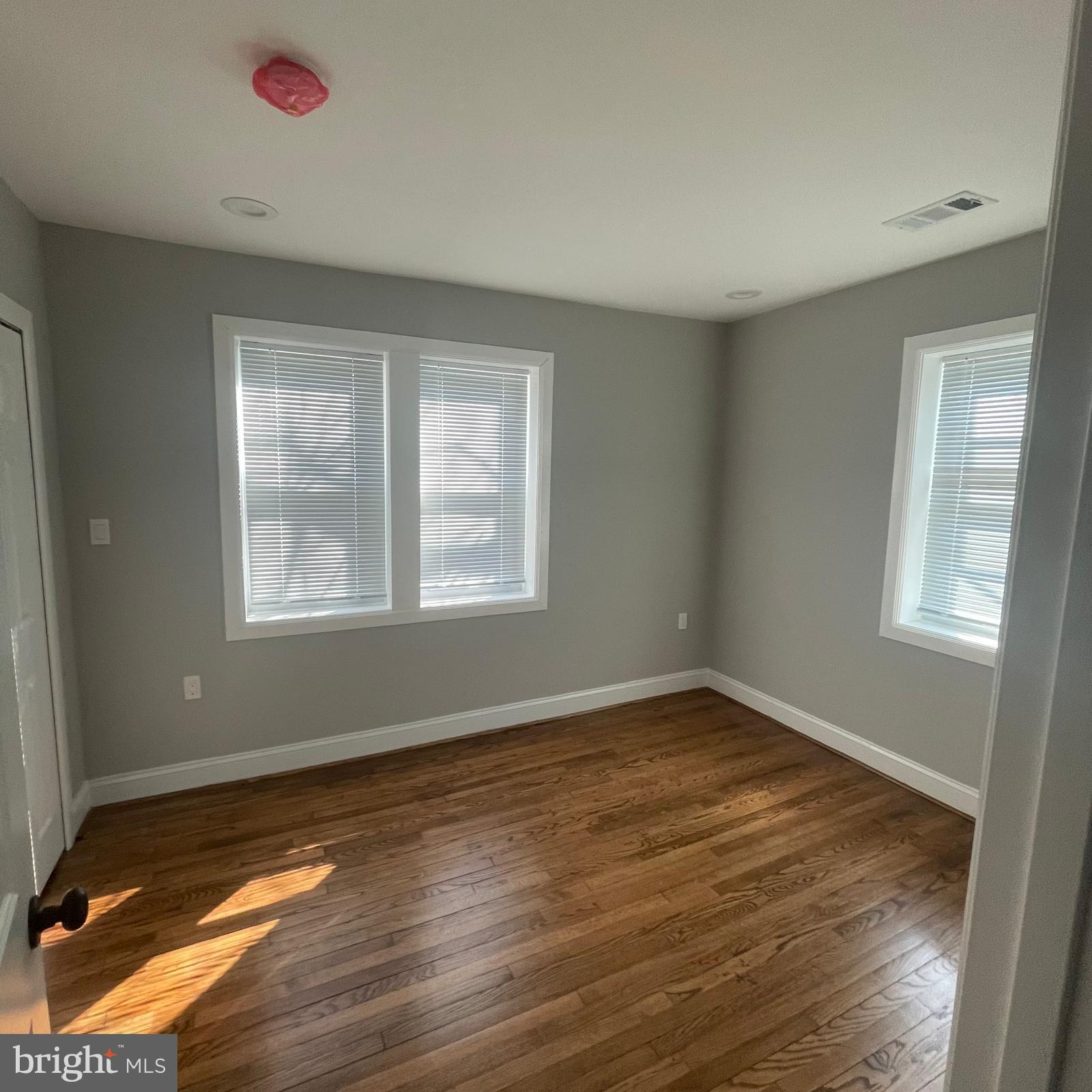 273 56th Place Northeast Washington, DC 20019 - Photo 9 of 25 a view of an empty room with wooden floor and a window