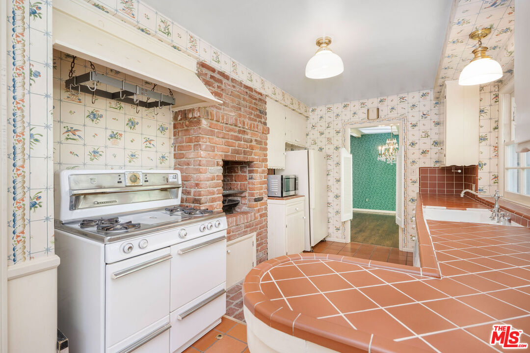 3520 Longridge Avenue Sherman Oaks, CA 91423 - Photo 14 of 37 a kitchen with a stove a sink and a refrigerator