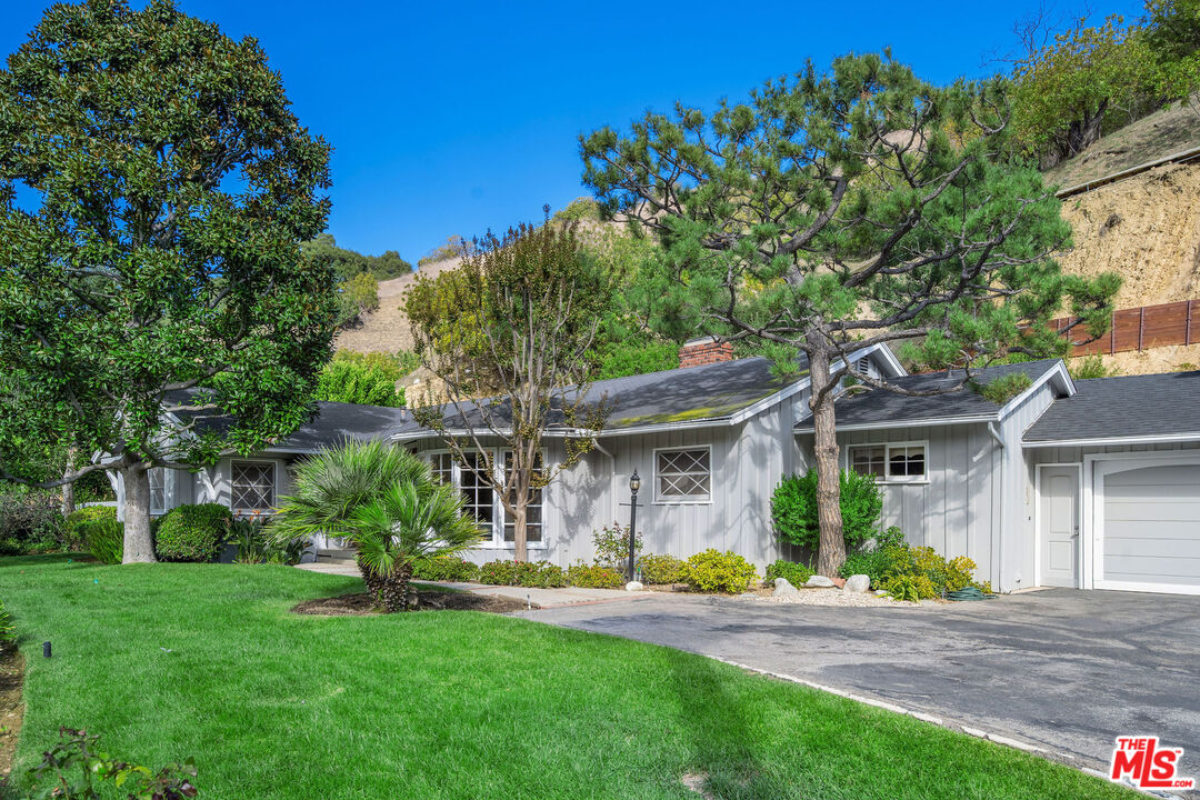 3520 Longridge Avenue Sherman Oaks, CA 91423 - Photo 2 of 37 a front view of a house with garden