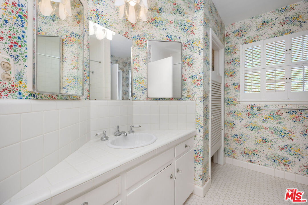 3520 Longridge Avenue Sherman Oaks, CA 91423 - Photo 24 of 37 a bathroom with a sink a vanity and a mirror