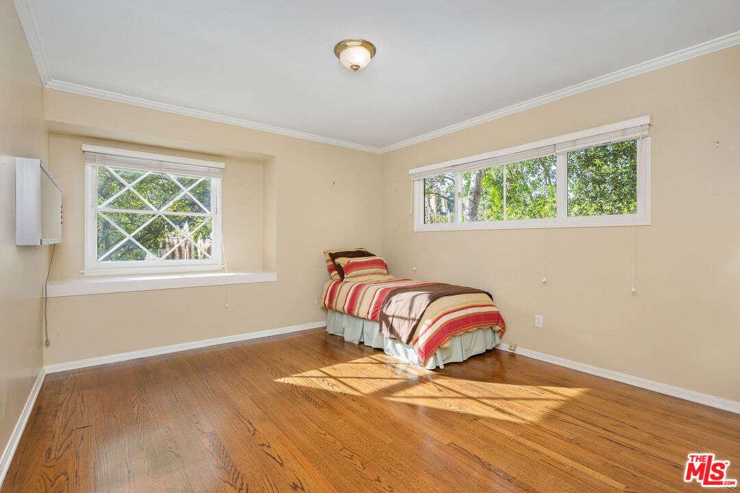 3520 Longridge Avenue Sherman Oaks, CA 91423 - Photo 25 of 37 a bedroom with a bed and a window