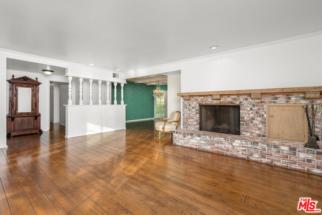 3520 Longridge Avenue Sherman Oaks, CA 91423 - Photo 10 of 37 a view of empty room with wooden floor and fireplace