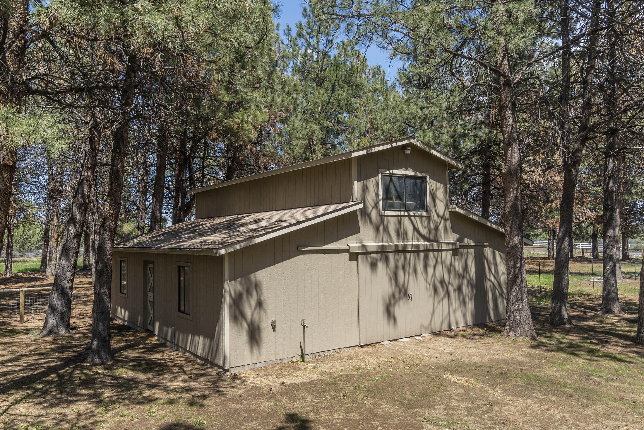 60603 Woodside Road Bend, OR 97702 - Photo 30 of 36 a view of a wooden house with large trees