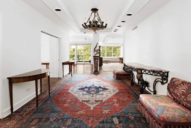 a living room with furniture and a chandelier