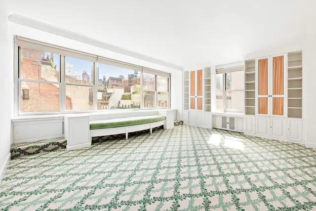 a bedroom with bed and large windows