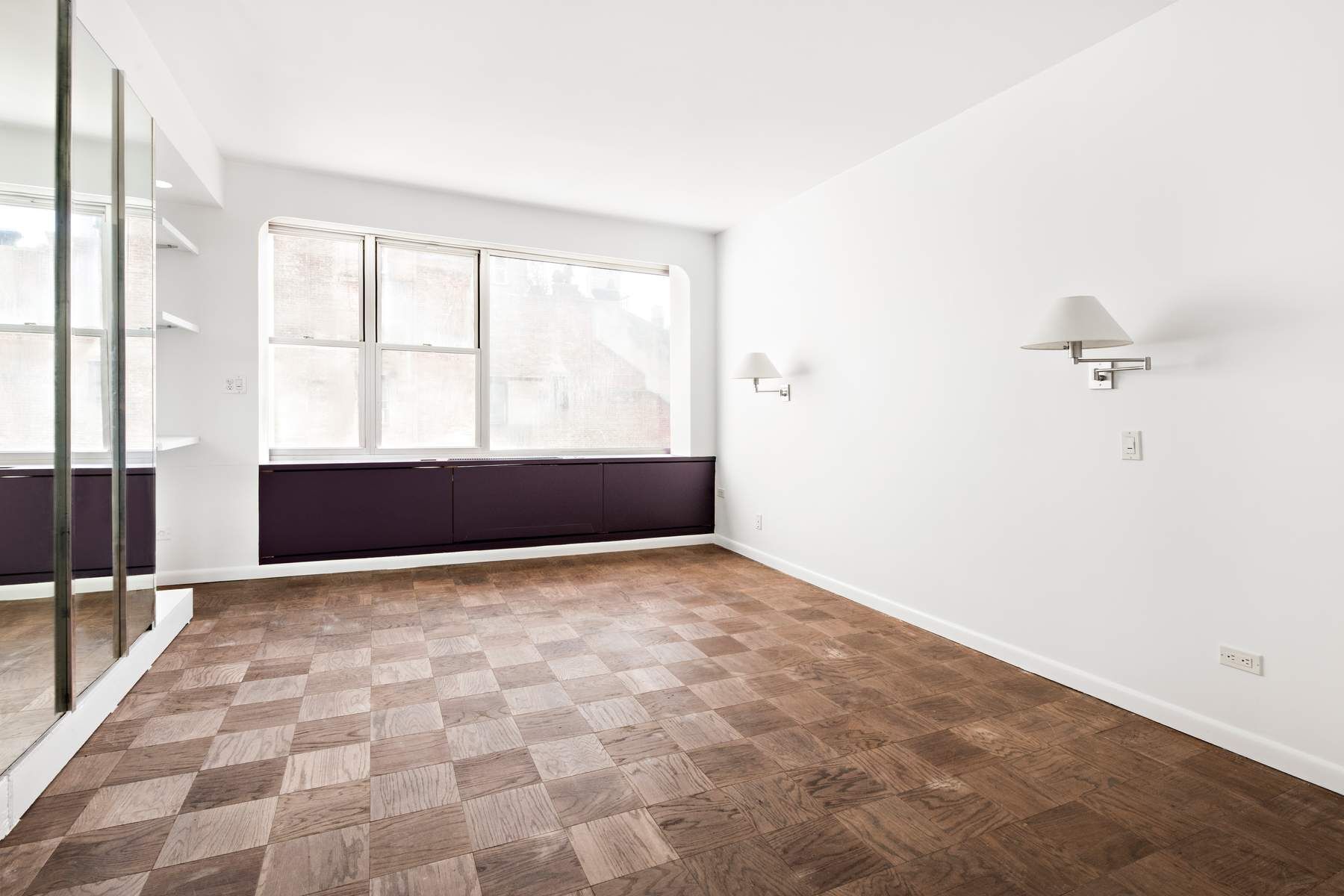 857 5th Avenue, Unit 7 Manhattan, NY 10065 - Photo 17 of 22 a view of empty room with wooden floor and fan