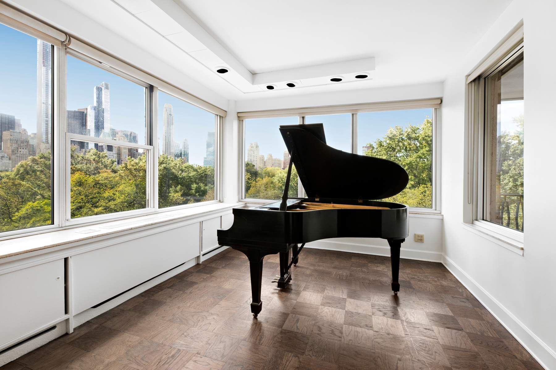 857 5th Avenue, Unit 7 Manhattan, NY 10065 - Photo 7 of 22 a living room with furniture and a large window