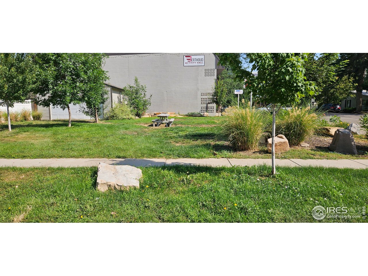615 4th Street Berthoud, CO 80513 - Photo 2 of 4 a backyard of a house with a garden and outdoor seating
