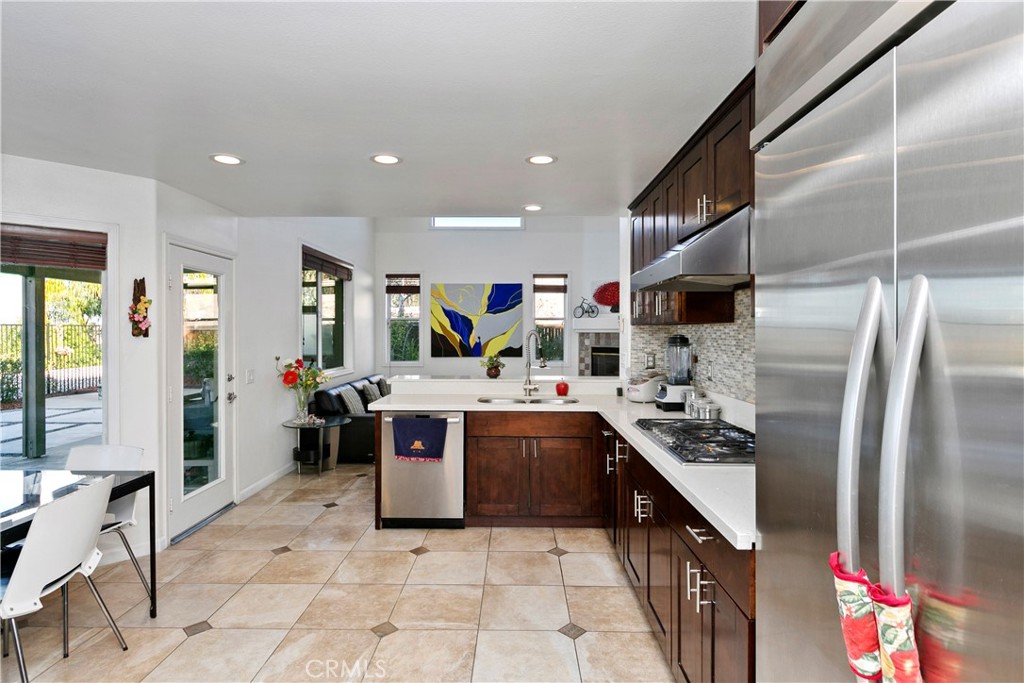 747 Donatello Drive Corona, CA 92882 - Photo 12 of 56 a kitchen with stainless steel appliances granite countertop a sink and a refrigerator