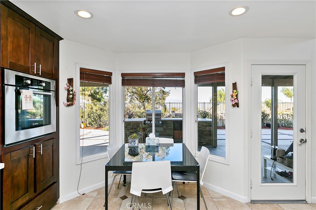 747 Donatello Drive Corona, CA 92882 - Photo 13 of 56 a view of a dining room with furniture window and wooden floor