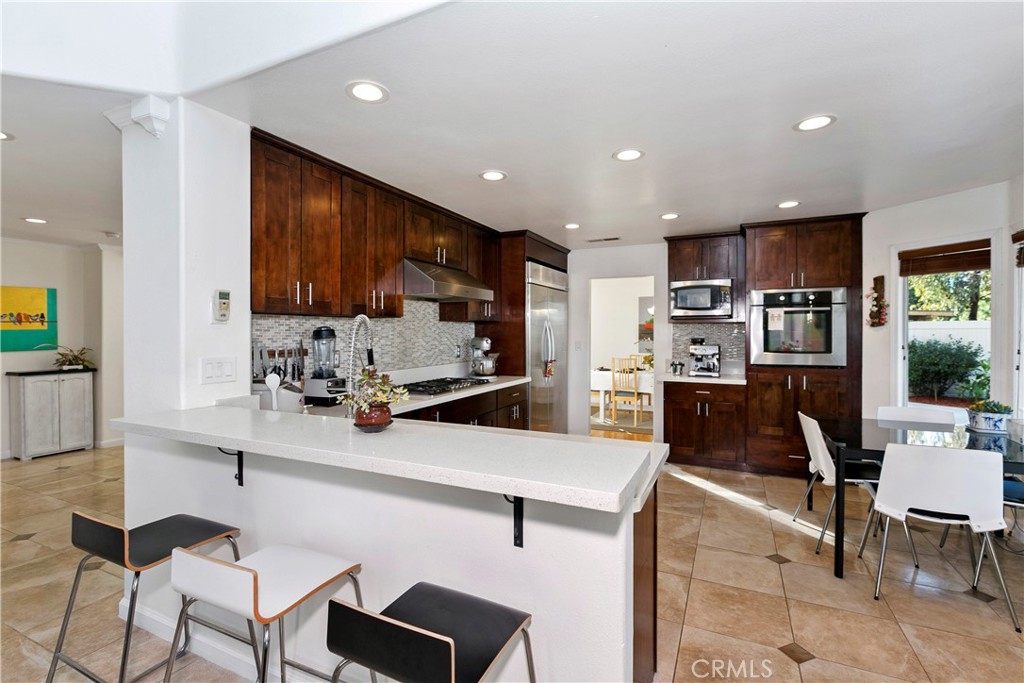 747 Donatello Drive Corona, CA 92882 - Photo 15 of 56 a kitchen with stainless steel appliances kitchen island granite countertop a sink and cabinets