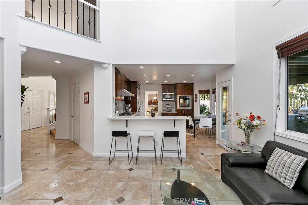 747 Donatello Drive Corona, CA 92882 - Photo 16 of 56 a living room with furniture and a dining table with kitchen view