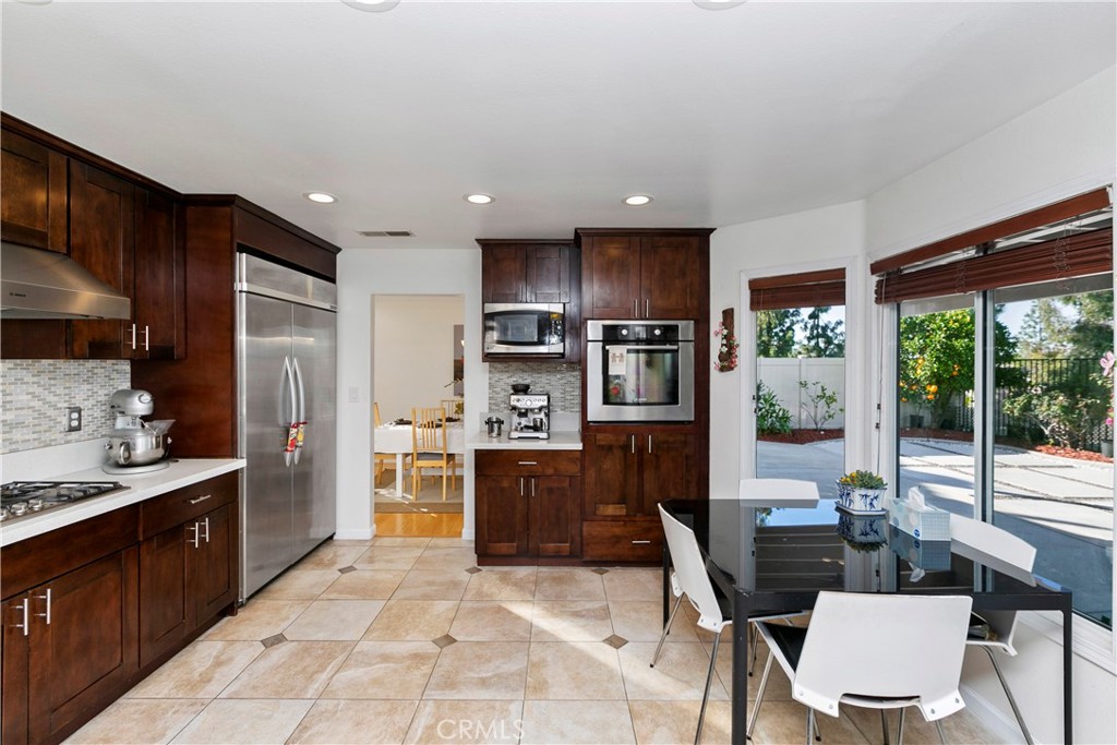 747 Donatello Drive Corona, CA 92882 - Photo 19 of 56 a kitchen with stainless steel appliances kitchen island granite countertop a refrigerator and a stove top oven
