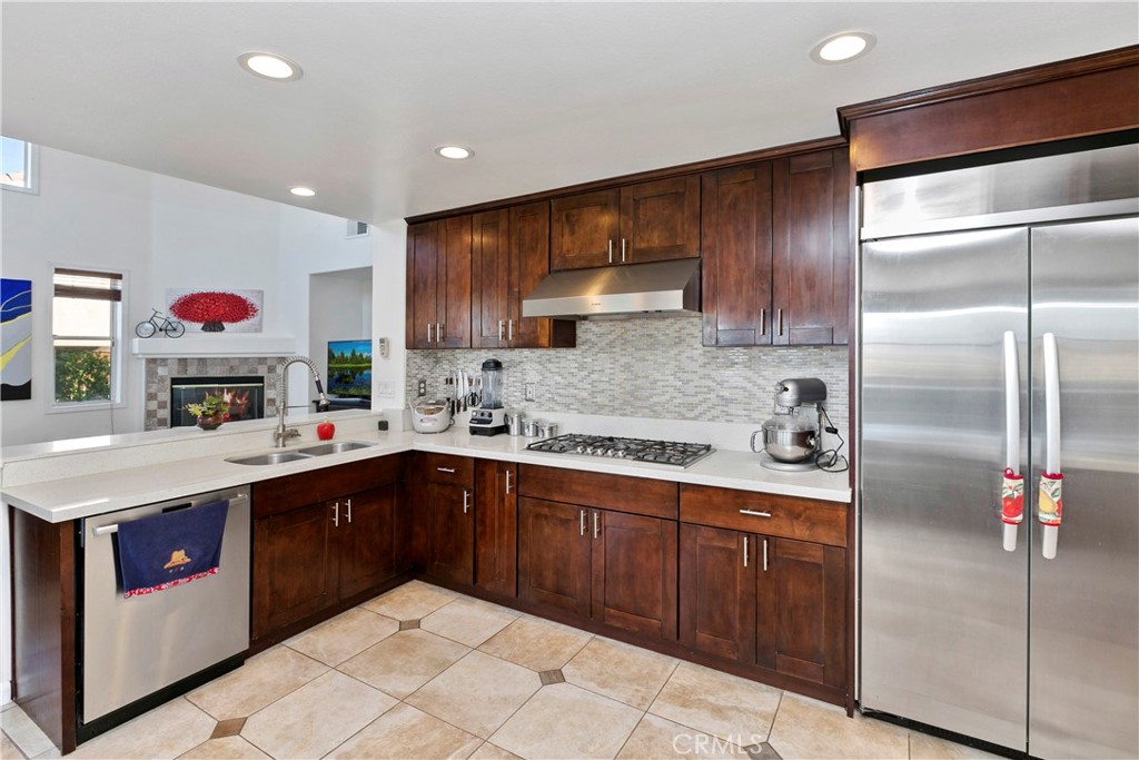 747 Donatello Drive Corona, CA 92882 - Photo 20 of 56 a kitchen with kitchen island granite countertop a sink stainless steel appliances and cabinets