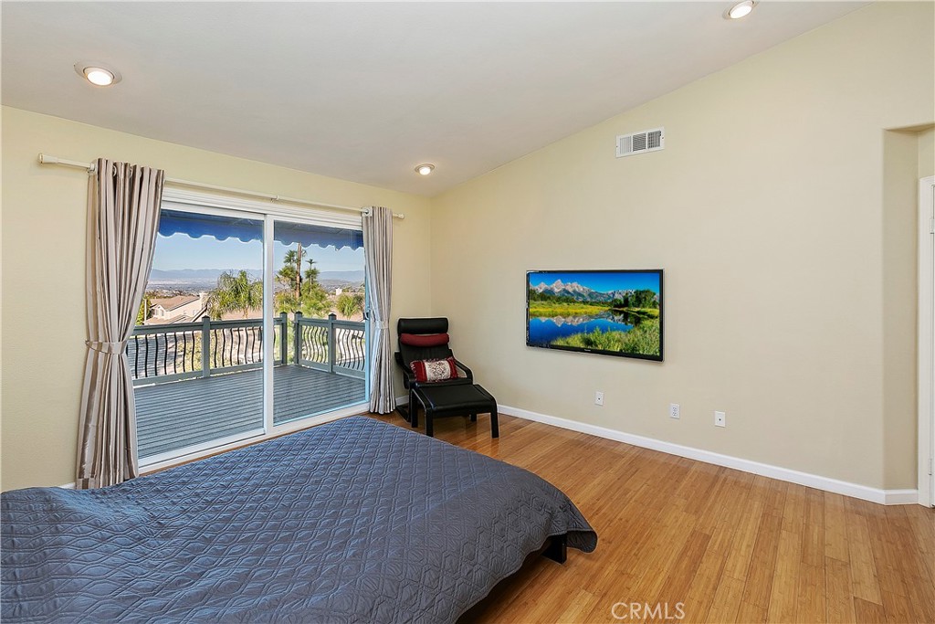 747 Donatello Drive Corona, CA 92882 - Photo 29 of 56 a bedroom with a bed and a painting on the wall