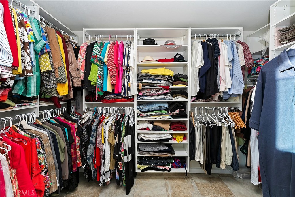 747 Donatello Drive Corona, CA 92882 - Photo 34 of 56 a view of walk in closet with clothes