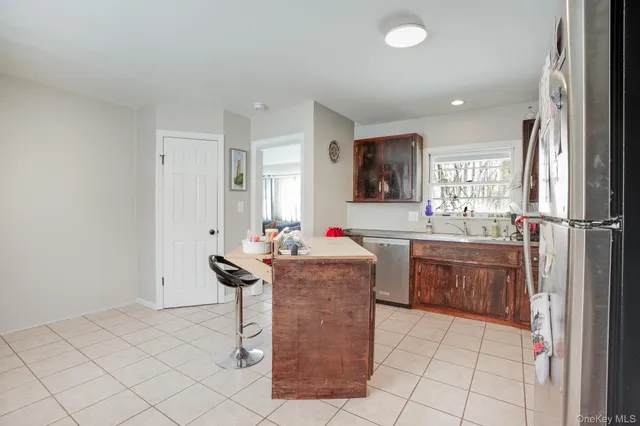 a living room with granite countertop furniture and a wooden floor