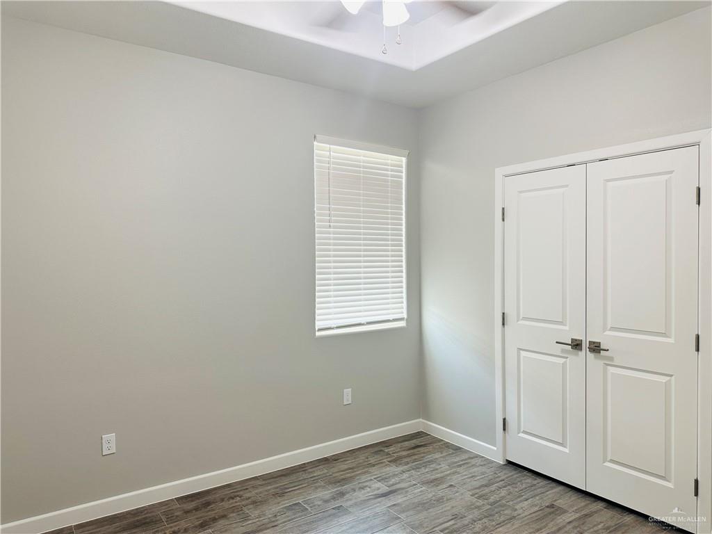 1101 Sugar Gdn Drive, Unit 1 Pharr, TX 78577 - Photo 7 of 10 an empty room with wooden floor