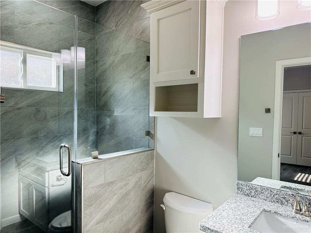 1101 Sugar Gdn Drive, Unit 1 Pharr, TX 78577 - Photo 9 of 10 a bathroom with a sink toilet and shower